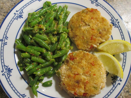 Salmon patties, made from fresh-frozen (not canned) salmon.  Served with lemon wedges and greenbeans in a cornichon-honey-mustard dressing.