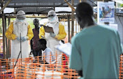 deadly
      : A Doctors Without Borders 
      
       medical worker, wearing protective clothing relays patient details and updates behind a barrier to a colleague at a
      
       facility in Kailahun, Sierra Leone. Kailahun and 
      
       Kenama district are 
      
       the epicentre of the world's worst 
      
      ebola outbreak
    
      pHOTO: Carl de Souza/AFP