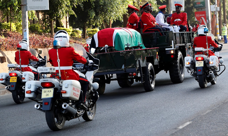 Military officers march in a procession as they escort the coffin of late former Kenya's President Daniel Arap Moi, draped in the National Flag, from the Lee Funeral Home on its way to Lie-in-State for public viewing at the Parliament Buildings in Nairobi./REUTERS