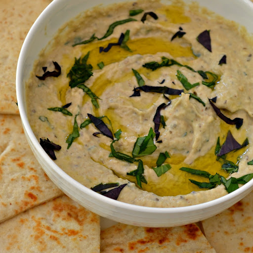 Baba Ganoush is a simple Middle Eastern Dip made with Roasted Eggplant, Tahini, lemon juice, garlic and other delectable seasonings.  It is traditionally served with warm pita bread. 