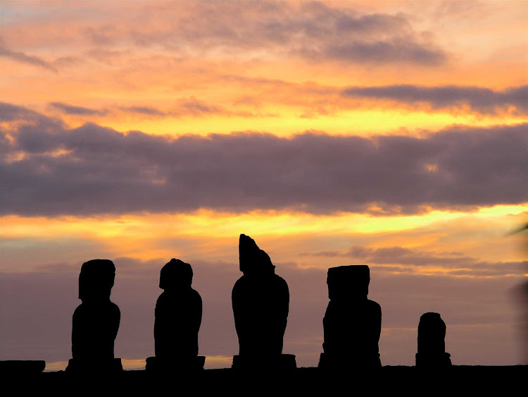 Sunset with the row of five moai on Easter Island. 