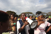 Flood victims protest at an ANC KwaZulu-Natal provincial council meeting in Mayville, demanding houses.