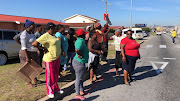 Community members from the Joe Slovo informal settlement outside the New Brighton Magistrate’s Court on 16 April 2018 to support a man who flung his daughter from the roof of a shack. 