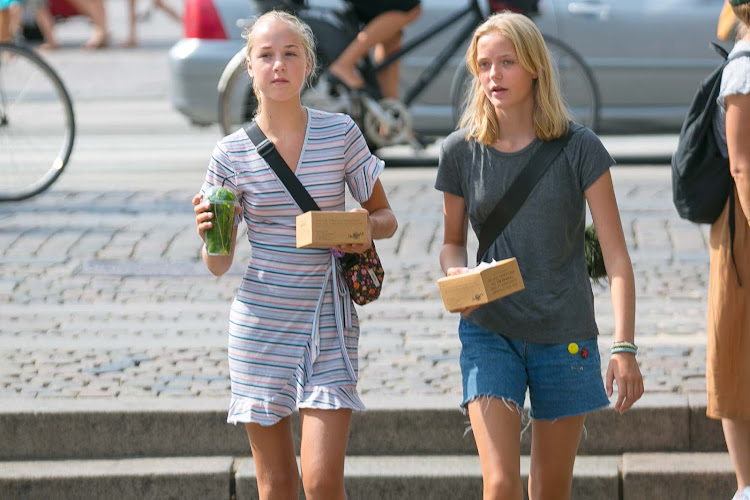 Danish teen girls in a public plaza in the popular Nyhavn section of Copenhagen. 