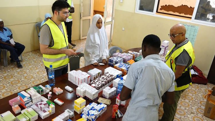 Medical personnel working for Omeriye Foundation issue drugs to children at the Malindi Islamic Orphanage Centre during a medical camp organised by two NGOs from Turkey and Belgium in Kilifi and Tana River.