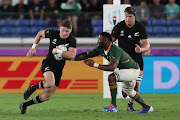 The All Blacks' Beauden Barrett breaks past Springbok captain Siya Kolisi during the Rugby World Cup 2019 Group B game in Yokohama, Kanagawa, Japan. New Zealand were 23-13 victors.