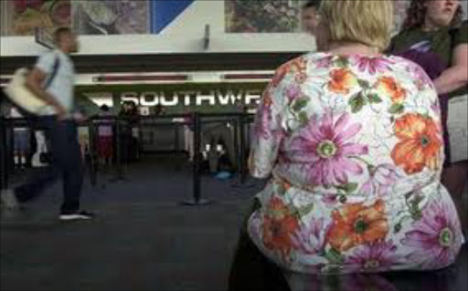 Passengers waits board an airline check-in counter