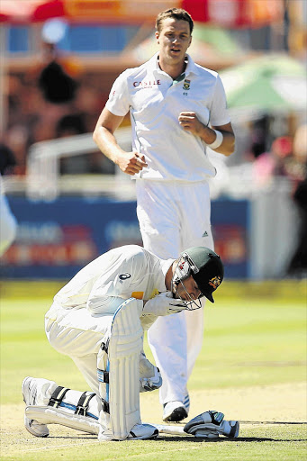 MAN DOWN: Michael Clarke sinks to his knees after being hit by a delivery from Morne Morkel during the third Test between South Africa and Australia at Newlands earlier this month