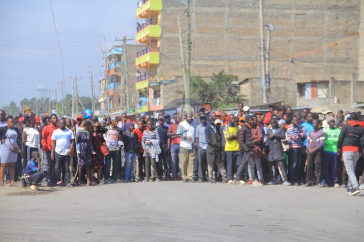 The public watches in disbelief from a distance the aftermath of the gas explosion that has so far left three people dead and over 200 hospitalised on February 2, 2024