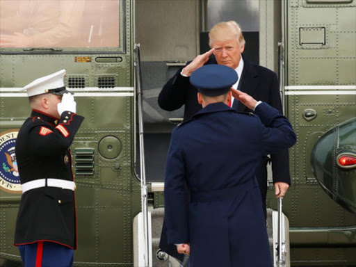 U.S. President Donald Trump returns a salutes as he steps from Marine One to board Air Force One upon his departure from Joint Base Andrews in Maryland, U.S., February 17, 2017. /REUTERS