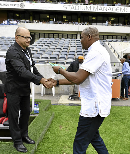 Sudan coach Zdravko Logarusic and his SA counterpart Molefi Ntseki exchange greetings before their Africa Cup of Nations qualifier in front of empty stands in Soweto yesterday.