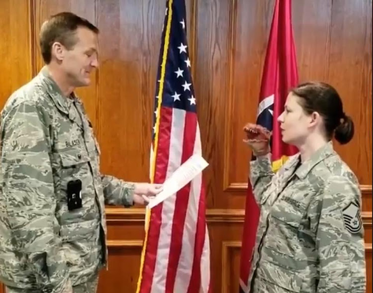 A video of a Master-Sergeant Robin Brown taking her oath of re-enlistment while holding a dinosaur puppet has sparked outrage.