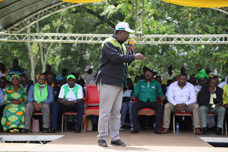 ANC Party leader Musalia Mudavadi and Ford Kenya leader Moses Wetang'ula (seated, in green shirt).