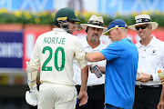 Anrich Nortje (L) of South Africa gets treament from team doctor during day 3 of the 3rd Test match between India and South Africa at JSCA International Stadium Complex on October 21, 2019 in Ranchi, India.