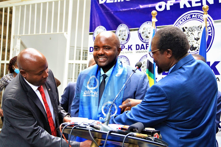 Democratic Action Party of Kenya deputy party leader Ayub Savula and party leader Wafula Wamunyinyi dress new member Butere MP Tindi Mwale during his welcoming on February 2, 2022/EZEKIEL AMING'A