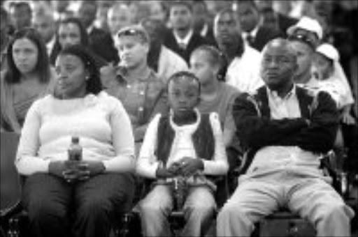 FINAL GOODBYE: Zola Tshetlo, Reitumetse Tshetlo and Sonnyboy Mmatli, an Ellis Park Disaster Co-ordinator, at the last disaster memorial service held at Ellis Park Stadium. Pic. Antonio Muchave. 11/04/07. © Sowetan.