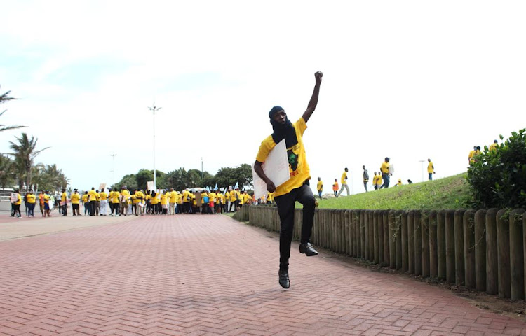 A man jumps at a picket opposing the disturbance of marine life.