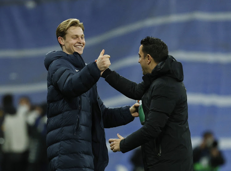 Barcelona coach Xavi celebrates with Frenkie de Jong after the match