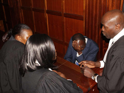 Migori Governor Okoth Obado with his lawyers at a Milimani court on Monday, September 24 where he was charged with the murder of Rongo University student Sharon Otieno, 26. /COLLINS KWEYU