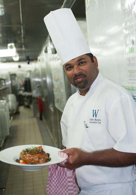 Eddie Barretto, executive chef of Wind Surf, with a prepared dish at the entryway to the ship's kitchen. 