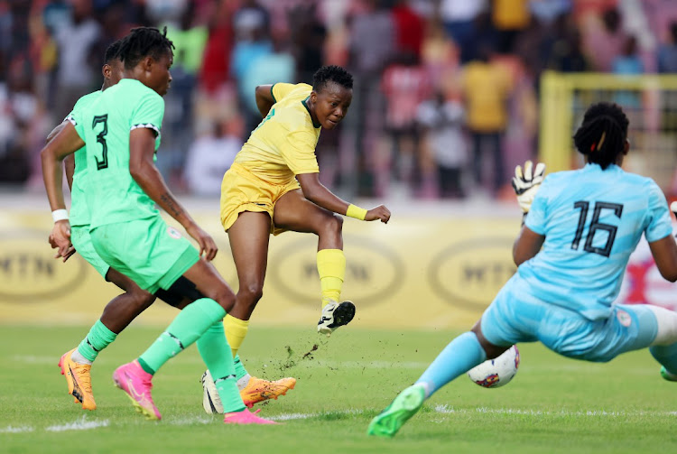 Thembi Kgatlana of South Africa challenged by Marvis Ohale and goalie Cynthia Nnadozie of Nigeria during Friday’s Olympics qualifier at the MKO Abiola Stadium, Abuja.