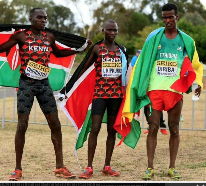 Ismail Kipkurui (C) with Reymond Cheruiyot and Ethiopia's Boki Diriba after winning world cross country title in Bathurst, Australia.