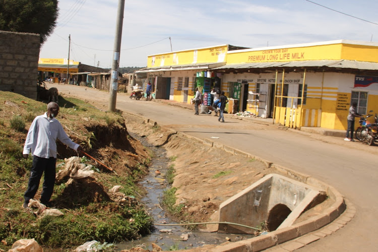 An old man points at a raw sewer in Eldama-Ravine town, Baringo on Thursday.