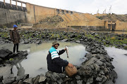  Esmeralda Olivier and Thuys Pieters collect fish from a kraal at the bottom of the Vanderkloof Dam wall.