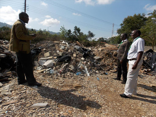 NEMA County Director, Machakos County Kennedy Odhiambo(left) with other staff from the environment regulatory authority at the condemned county waste damping site in Machakos town last year.Photo George Owiti