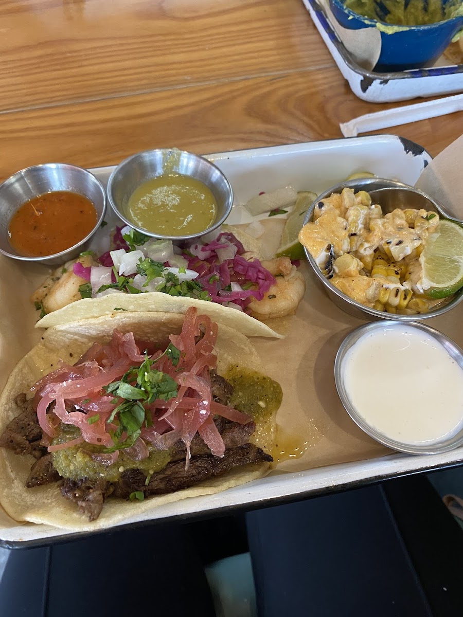 Shrimp taco and steak tacos with elote corn