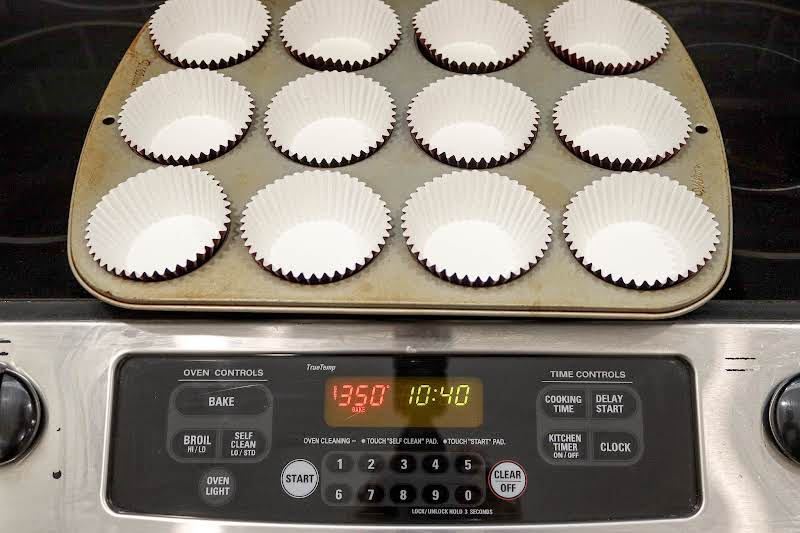 Lining Muffin Tins While Oven Preheats.