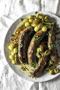 Sausages roasted with wine and grapes.