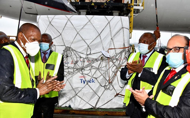 SA officials, health minister Zweli Mkhize, Deputy President David Mabuza and President Cyril Ramaphosa witness the arrival of Covid-19 vaccines in SA from India on Monday.