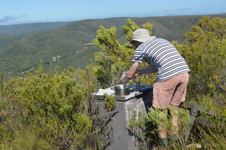 Ben Rogers brews hot water for coffee on top of Douwurmkop, above the Kalander Hut, near the start of the second day of the Tsitsikamma Hiking Trail