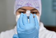 A healthcare worker prepares a dose of the Pfizer/BioNTech vaccine. File photo 