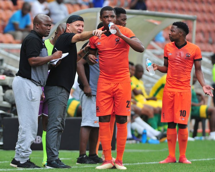 Polokwane City head coach Jozef Vukusic (wearing a cap) and his assistant Bernard Molekwa (L) dish out instructions to his players during an Absa Premiership match at Peter Mokaba Stadium in Polokwane.