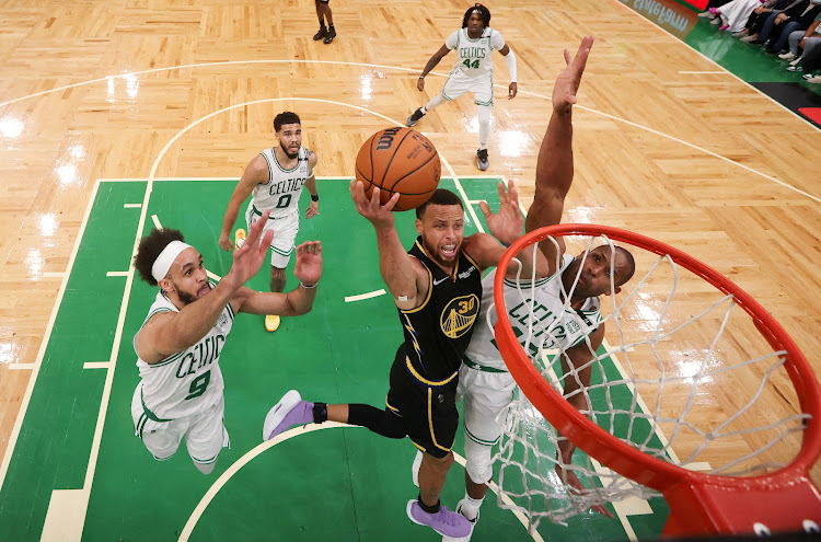 Golden State Warriors guard Stephen Curry (30) attempts a layup against Boston Celtics centre Al Horford (42) during the first quarter of game four in the 2022 NBA Finals at the TD Garden