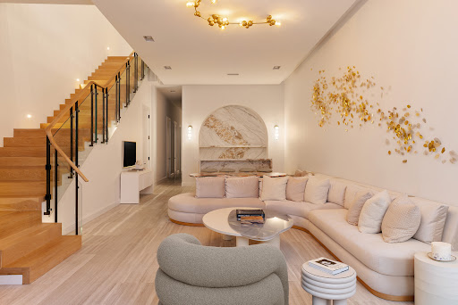 Buy this luxury apartment in New York (United States) - Modern living room with wooden stairs and curved sofa