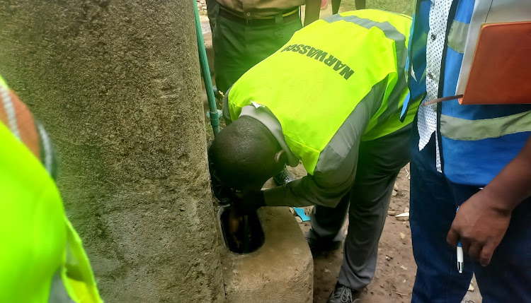 An official of Narok Water and Sewerage Company disconnects a tap that was diverted illegally people in Narok town.