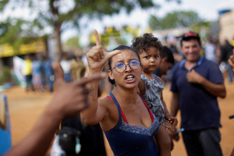 Supporter of Brazil's former President and presidential candidate Luiz Inacio Lula da Silva protest against Brazil's President and candidate for re-election Jair Bolsonaro during an election campaign of him at a settlement of rural workers in Brasilia, Brazil, on October 24 2022. Picture: REUTERS/ADRIANO MACHADO