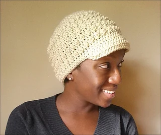 woman wearing a cream newsboy hat