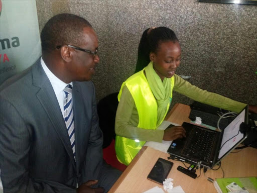 Nairobi governor Evans Kidero and IEBC voter registration officer Shambati./JULIUS OTIENO