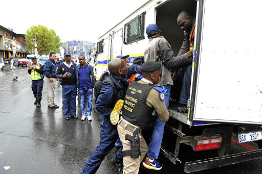 Police raiding counterfeit goods in the Johannesburg CBD. /Veli Nhlapo