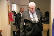 Former Bosasa executive sAngelo Agrizzi  and Andries van Tonder (back) appear at the Pretoria Commercial Crimes court.