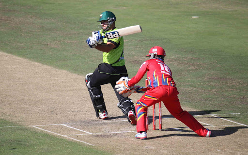 Warriors batsman Christiaan Jonker pulls a ball, while Lions wicket keeper, Thami Tsolekile watches on from behind the stump during the Momentum One Day Cup match at Buffalo Park Yesterday. Picture MICHAEL PINYANA