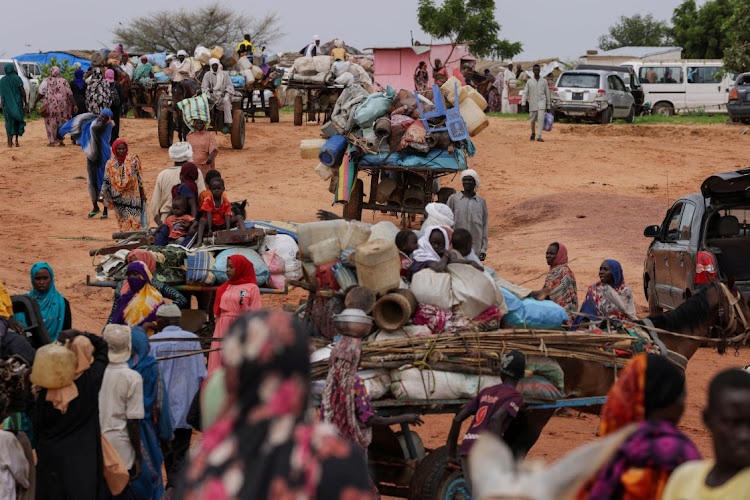 Chadian cart owners transport belongings of Sudanese people who fled the conflict in Sudan's Darfur region, while crossing the border between Sudan and Chad in Adre, Chad. Picture: ZOHRA BENSEMRA