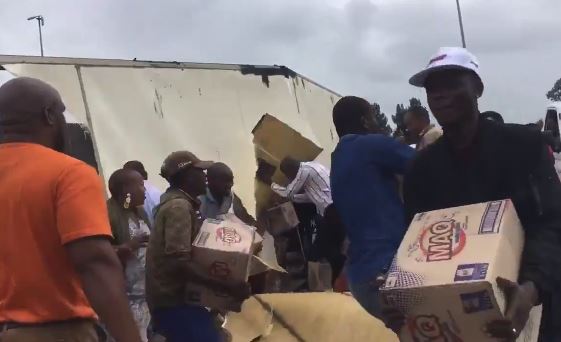 Looters helping themselves to some detergent from an overturned truck on the N1.