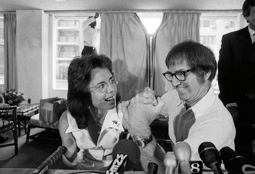 Billie Jean King and Bobby Riggs arm-wrestle at the announcement of their $100,000 winner-take-all tennis match in 1973.