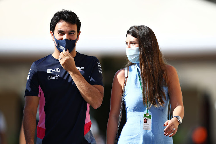 Sergio Perez of Mexico and Racing Point and his wife Carola Martinez Salido walk in the paddock before practice ahead of the F1 Grand Prix of Abu Dhabi at Yas Marina Circuit on December 11 2020.