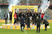 Orlando Pirates captain Thulani Hlatshwayo and his teammates celebrate after winning the 2020 MTN8 final as head caoch Josef Zinnbauer looks on.  